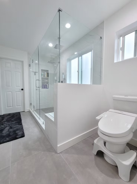 Walk-in shower with frameless glass and modern fixtures, installed for a homeowner in Kirkland