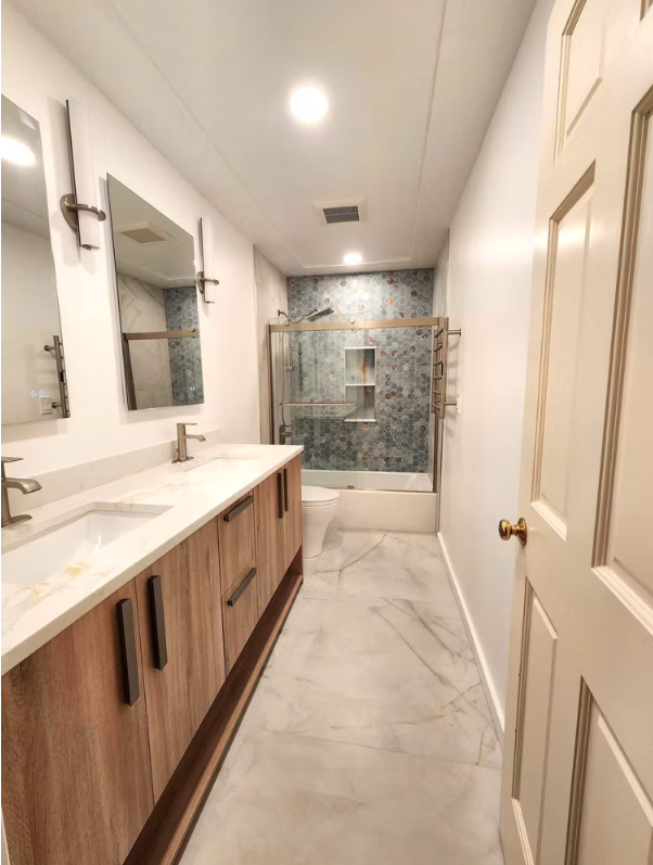 Dual rain shower heads with marble walls and built-in niche, installed for a homeowner in Seattle